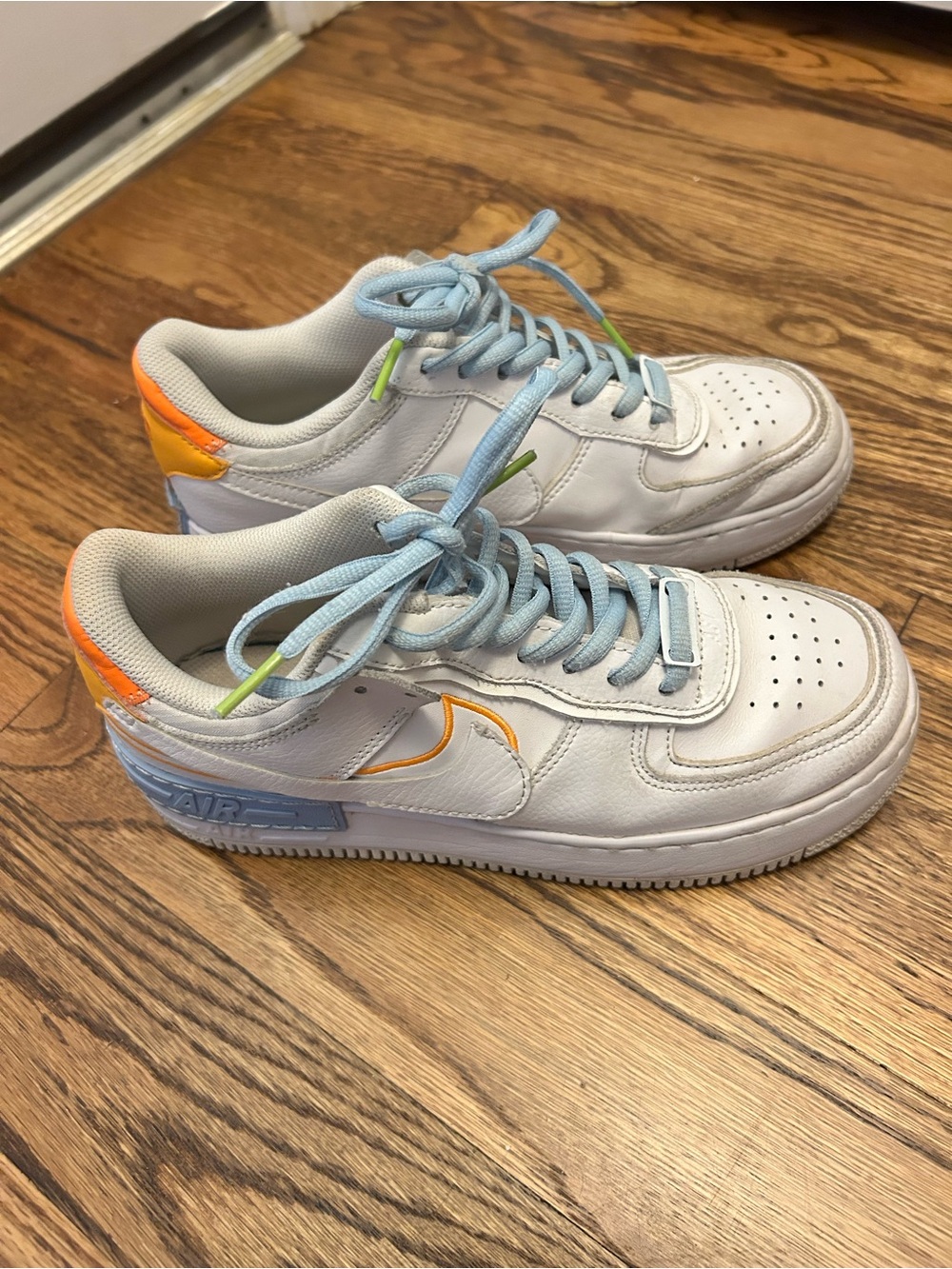 Nike White Low-Top Sneakers with Light Blue Laces and Orange Accents